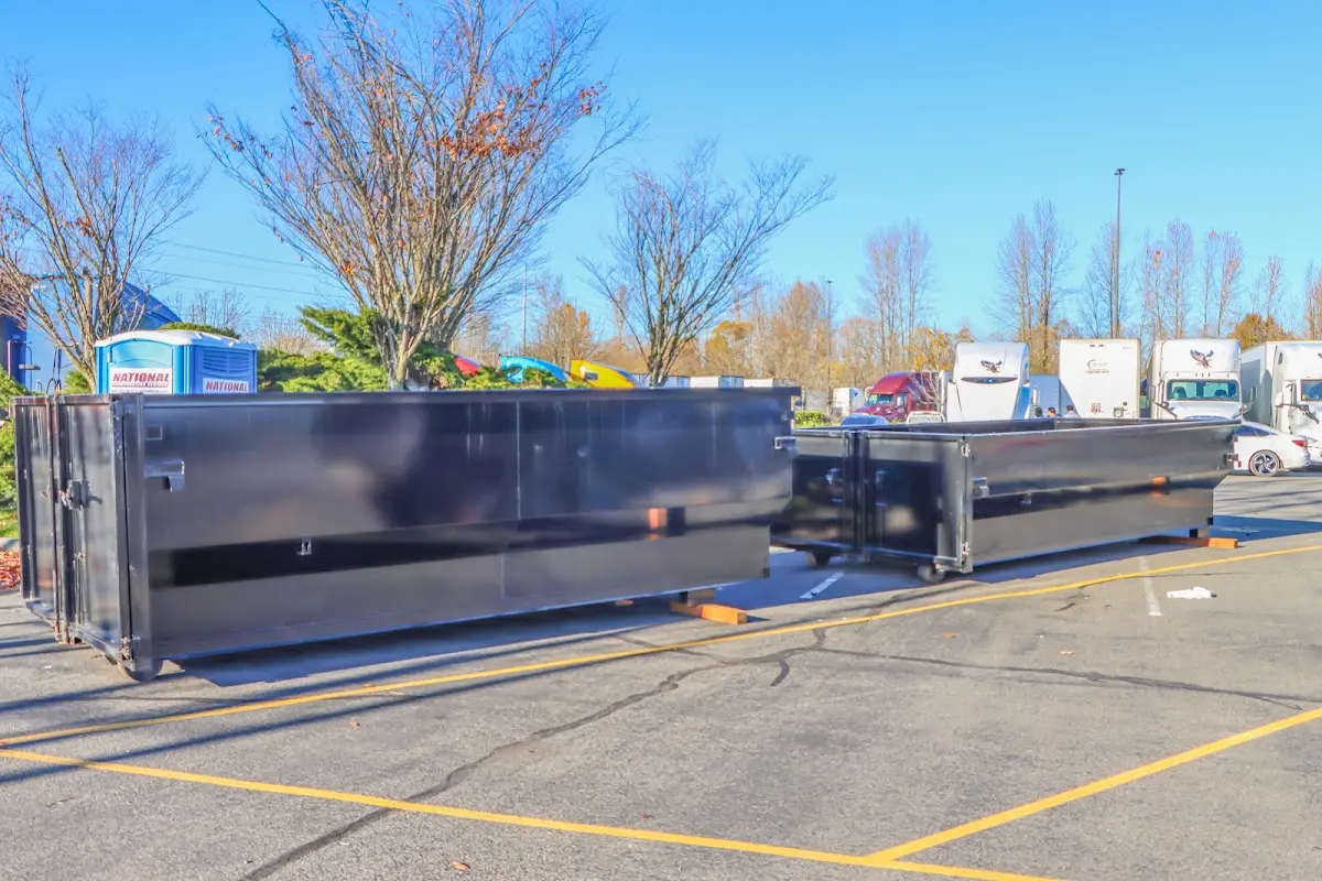 Professional dumpster rental service with roll-off container on residential driveway in National City